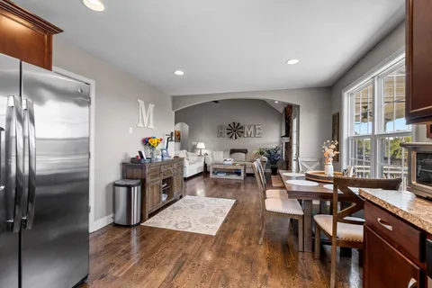 a very nice looking dining room with kitchen island a table and chairs