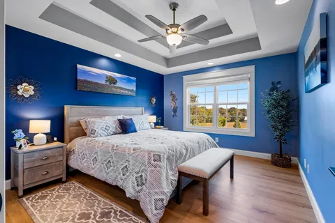 a bedroom with a bed and a chandelier