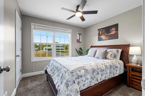 a bedroom with a large bed and a window