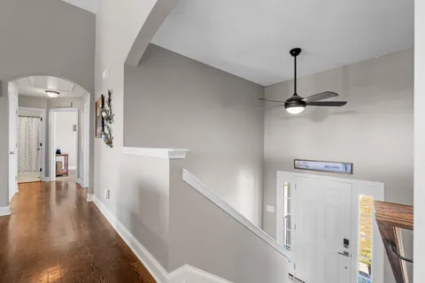 a view of a hallway with a white refrigerator freezer