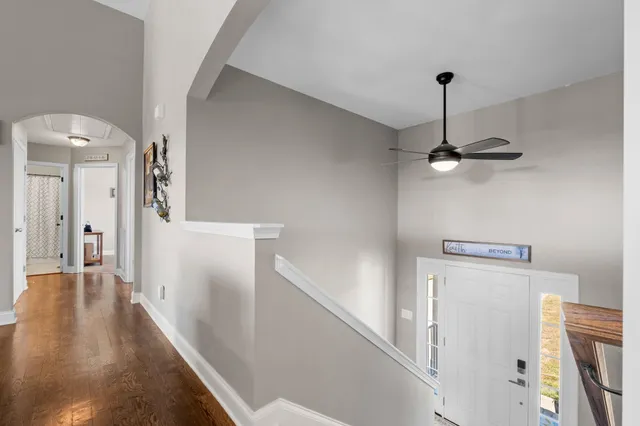 a view of a hallway with a white refrigerator freezer
