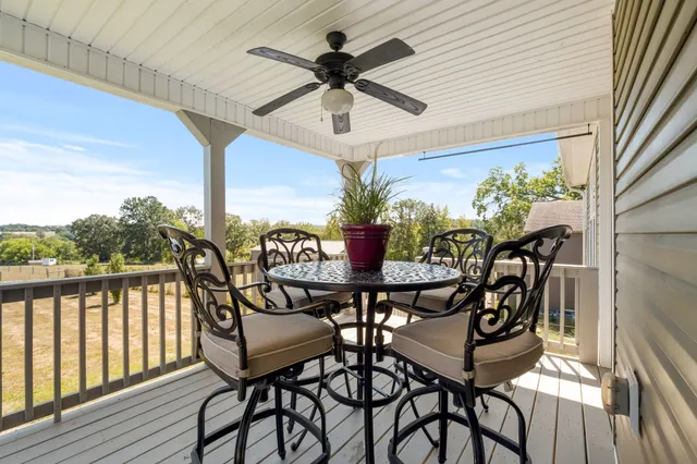 a view of a chairs and table in the balcony