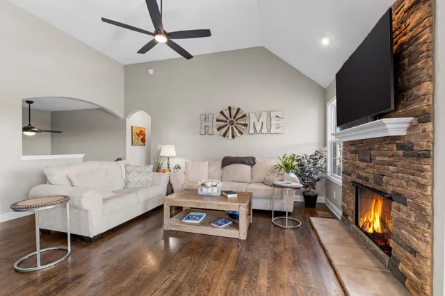 a living room with furniture fireplace and flat screen tv