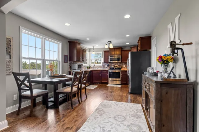 a view of a dining room with furniture window and wooden floor