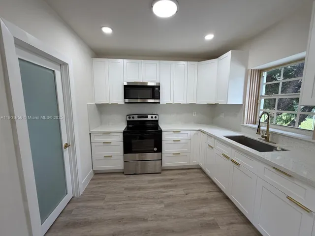a kitchen with stainless steel appliances a refrigerator stove and sink