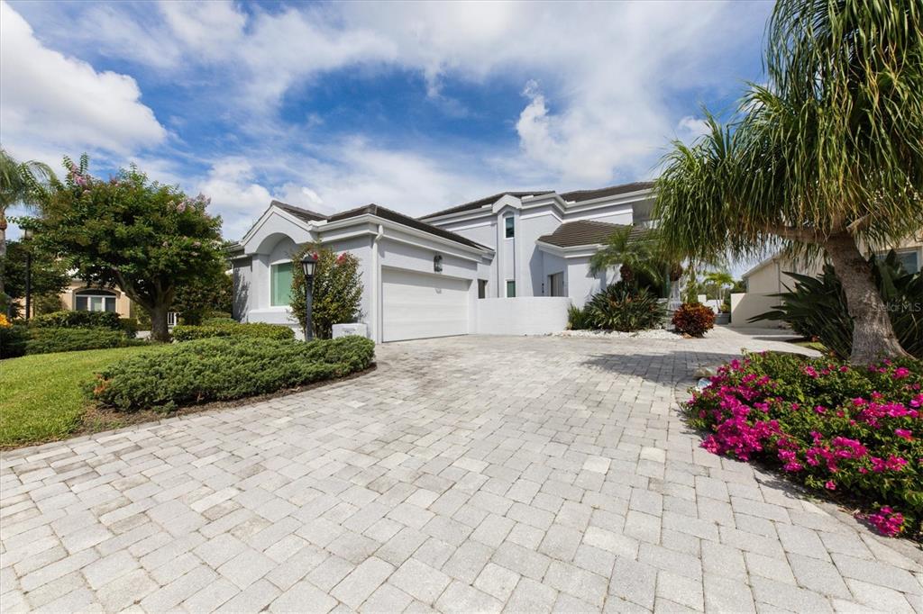 7716 Club Lane Sarasota, FL 34238 - Photo 12 of 68 a front view of a house with a yard and a garden