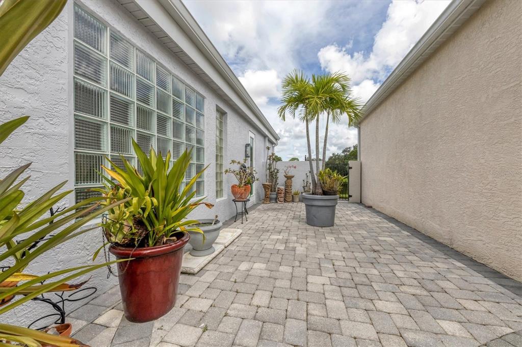 7716 Club Lane Sarasota, FL 34238 - Photo 16 of 68 a view of a path with potted plants