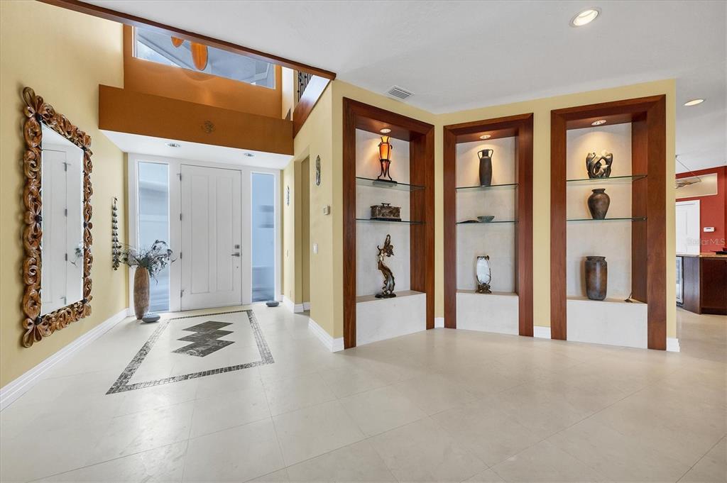 7716 Club Lane Sarasota, FL 34238 - Photo 17 of 68 a view of a hallway with bathroom and front door