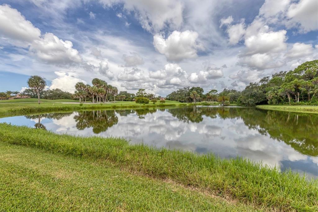 7716 Club Lane Sarasota, FL 34238 - Photo 2 of 68 a view of a lake with houses in the background