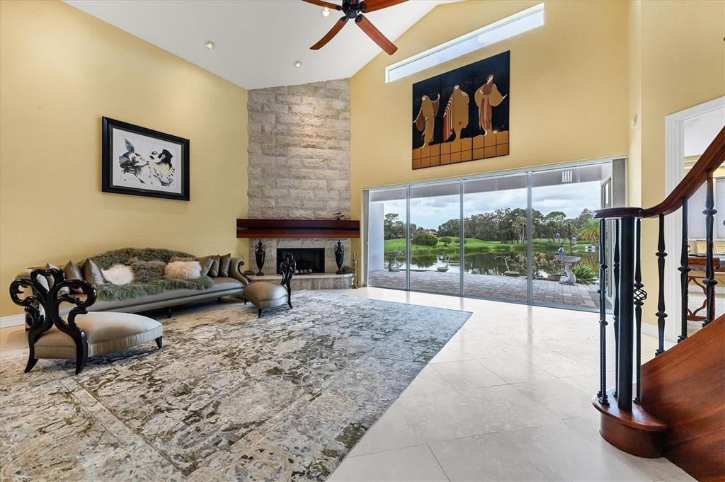 7716 Club Lane Sarasota, FL 34238 - Photo 21 of 68 a living room with furniture large window and a fireplace