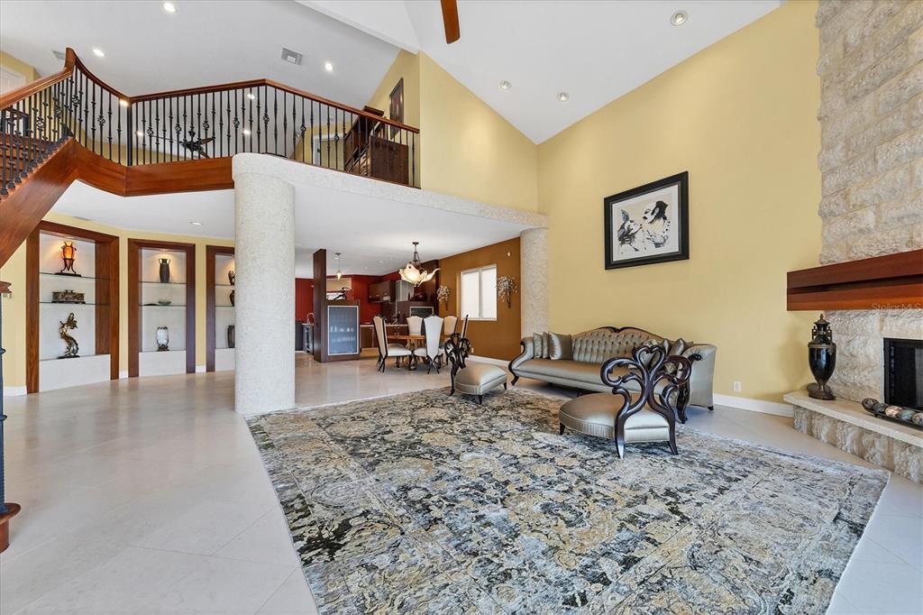 7716 Club Lane Sarasota, FL 34238 - Photo 23 of 68 a living room with furniture a fireplace and a table