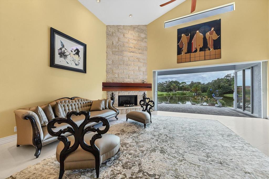 7716 Club Lane Sarasota, FL 34238 - Photo 25 of 68 a living room with furniture a fireplace and a large window