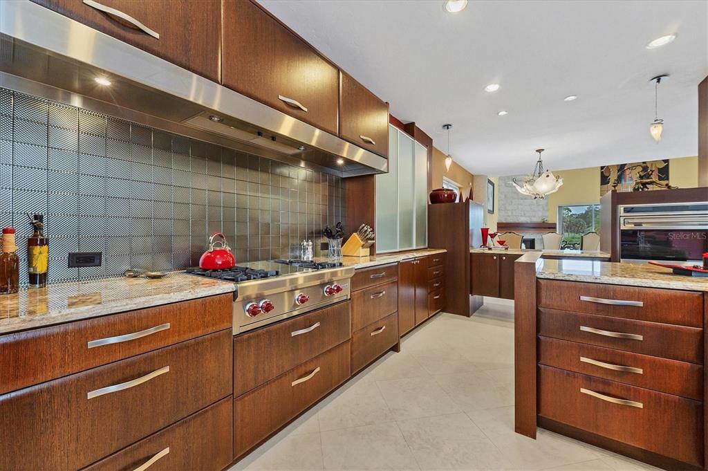 7716 Club Lane Sarasota, FL 34238 - Photo 31 of 68 a kitchen with stainless steel appliances granite countertop a sink and cabinets