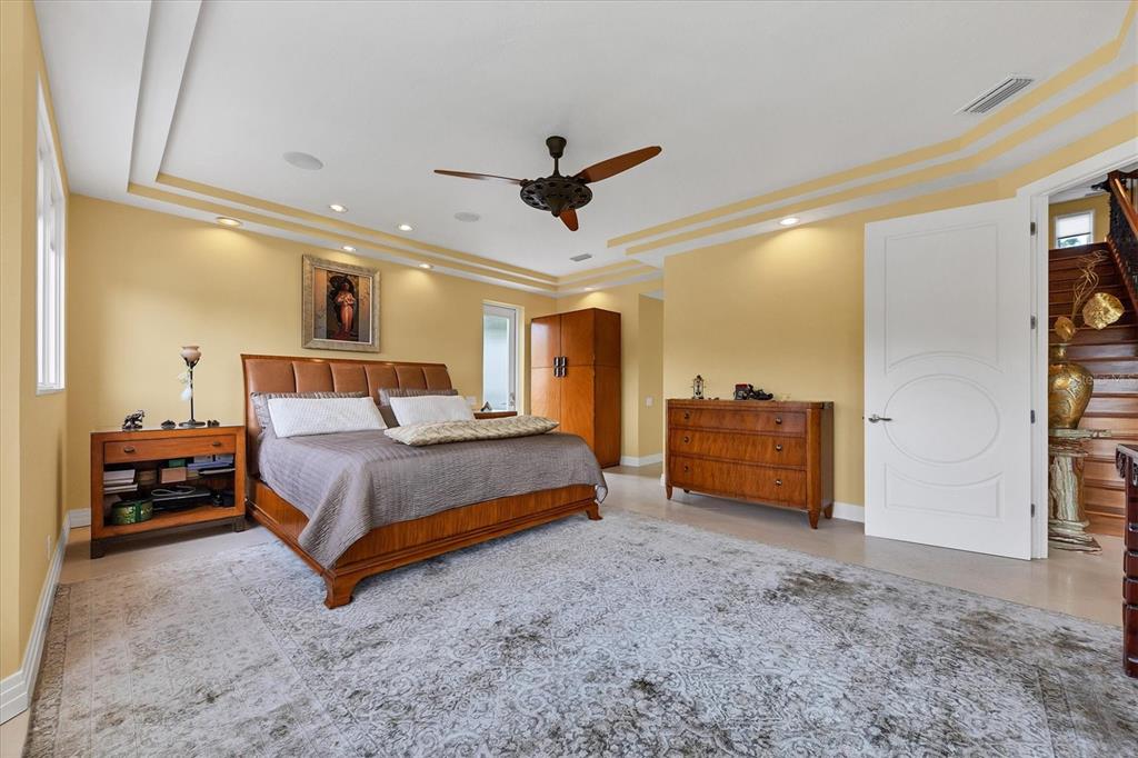 7716 Club Lane Sarasota, FL 34238 - Photo 34 of 68 a bedroom with a bed and a chandelier