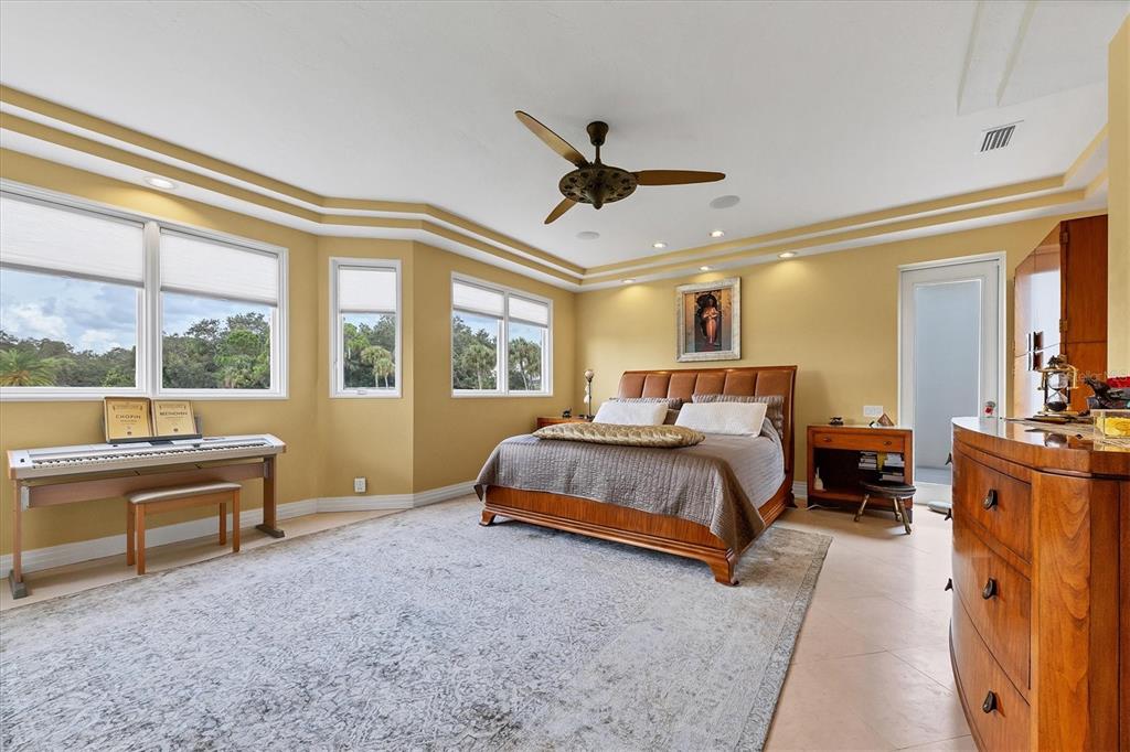 7716 Club Lane Sarasota, FL 34238 - Photo 35 of 68 a spacious bedroom with a bed and a large window