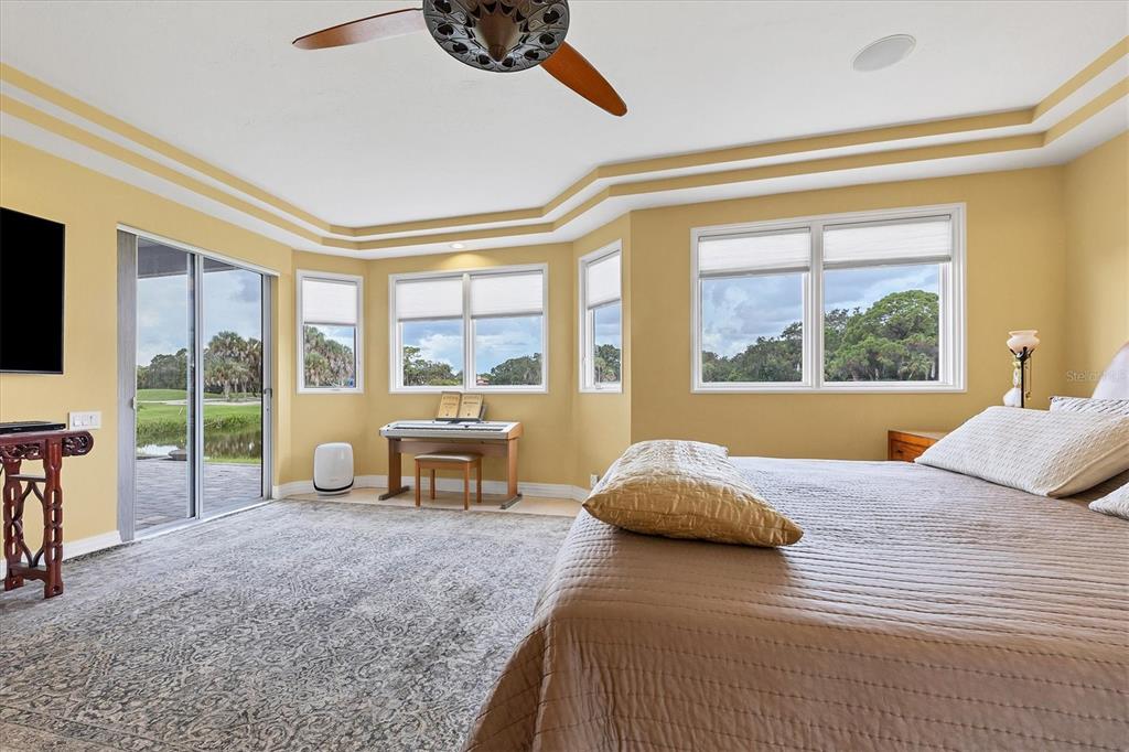 7716 Club Lane Sarasota, FL 34238 - Photo 36 of 68 a bedroom with a bed and large windows