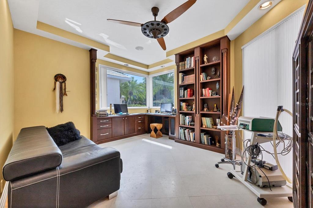 7716 Club Lane Sarasota, FL 34238 - Photo 39 of 68 a living room with furniture gym equipment and a large window