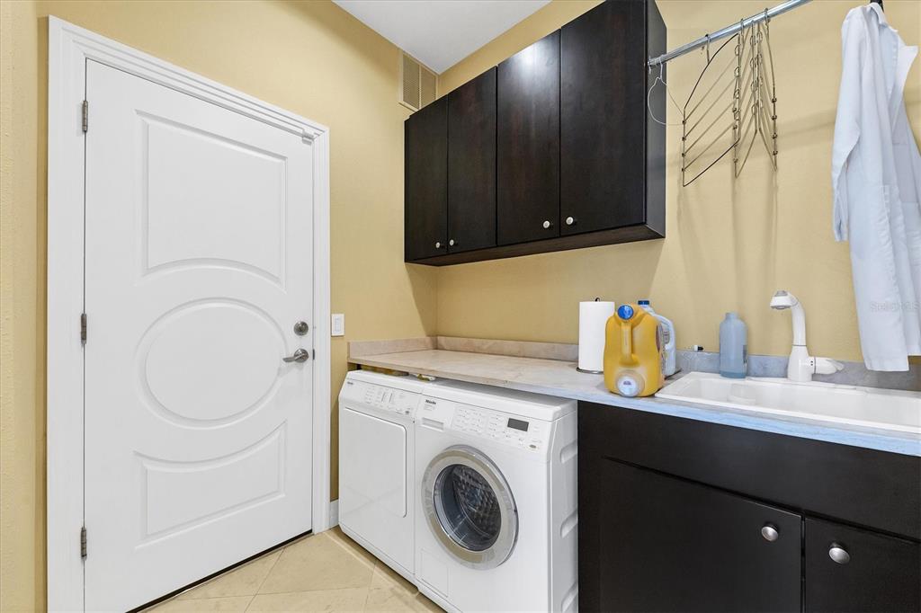 7716 Club Lane Sarasota, FL 34238 - Photo 42 of 68 a utility room with sink dryer and washer