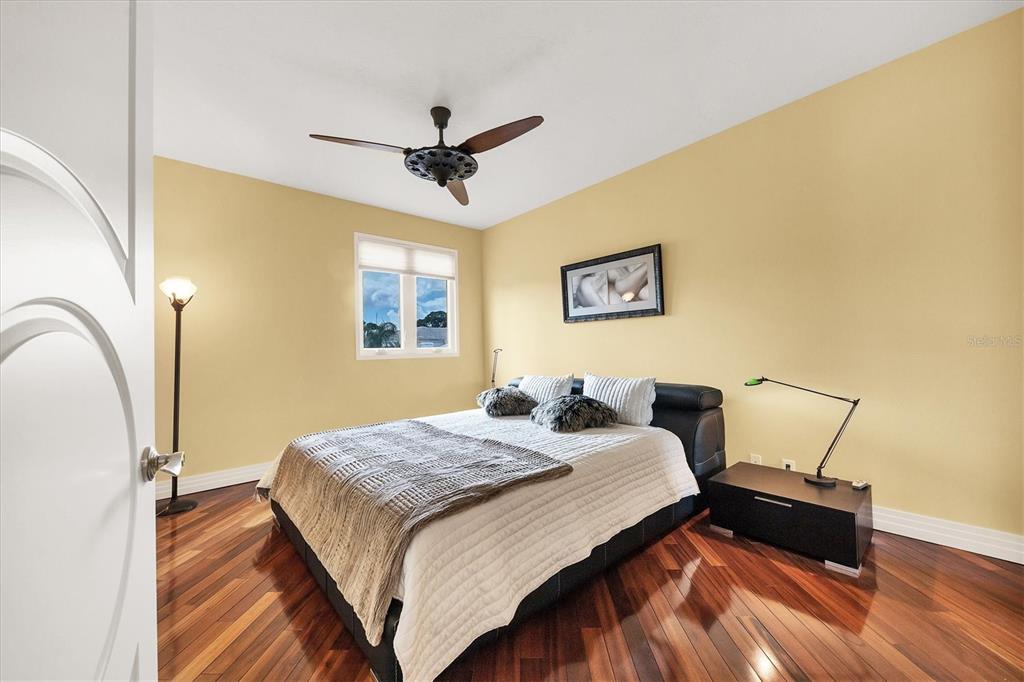 7716 Club Lane Sarasota, FL 34238 - Photo 47 of 68 a bedroom with a bed and wooden floor