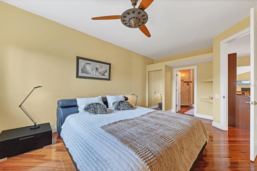 7716 Club Lane Sarasota, FL 34238 - Photo 48 of 68 a bedroom with a bed and wooden floor