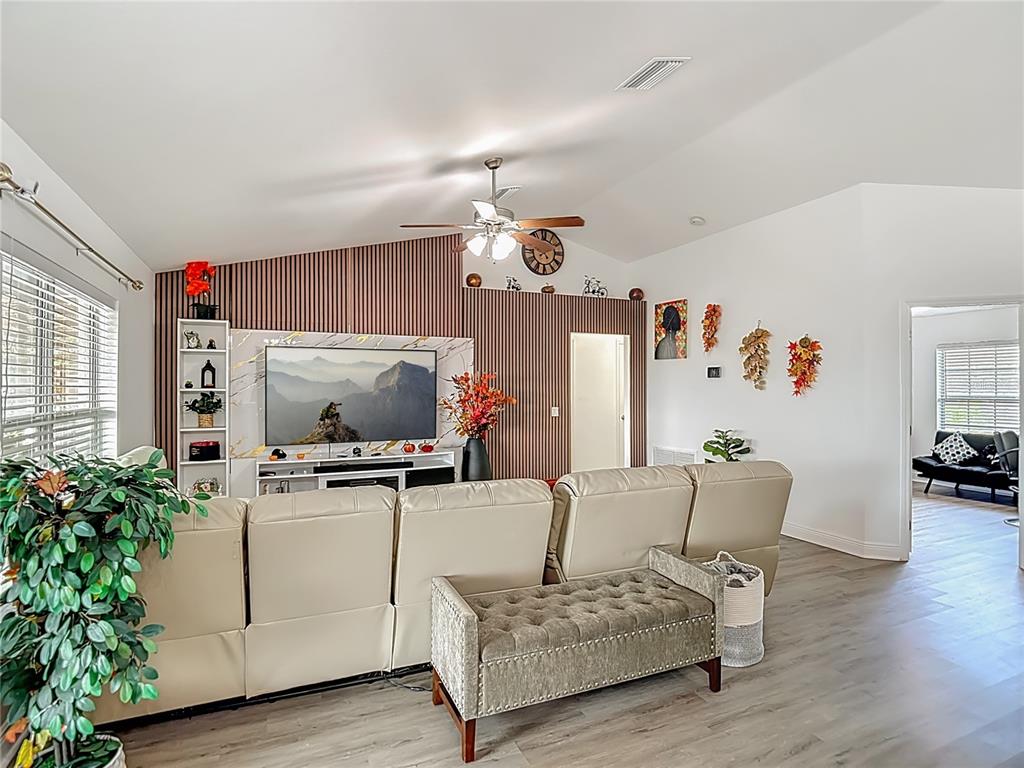 13108 Oneida Street Spring Hill, FL 34609 - Photo 11 of 62 a living room with furniture and flowers