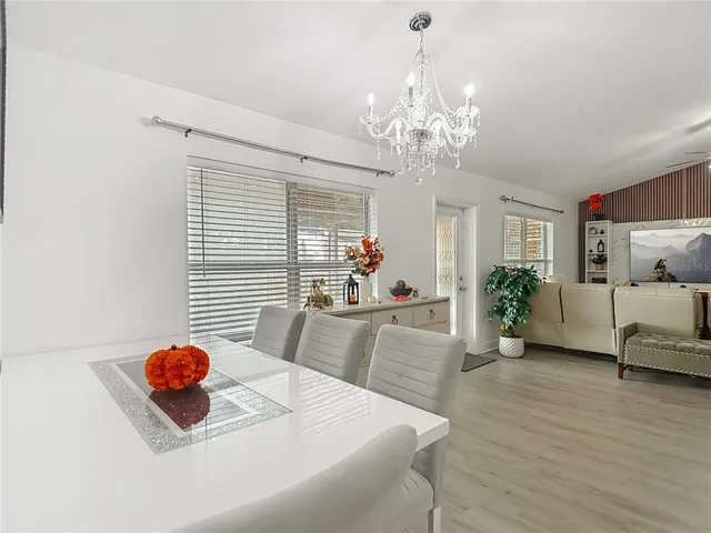 a large kitchen with stainless steel appliances granite countertop a refrigerator a stove a sink a counter space and cabinets