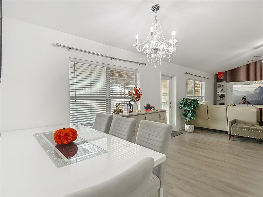 13108 Oneida Street Spring Hill, FL 34609 - Photo 14 of 62 a living room with furniture and a chandelier