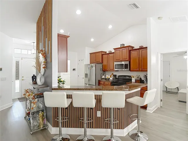 a kitchen with stainless steel appliances granite countertop a sink stove and cabinets