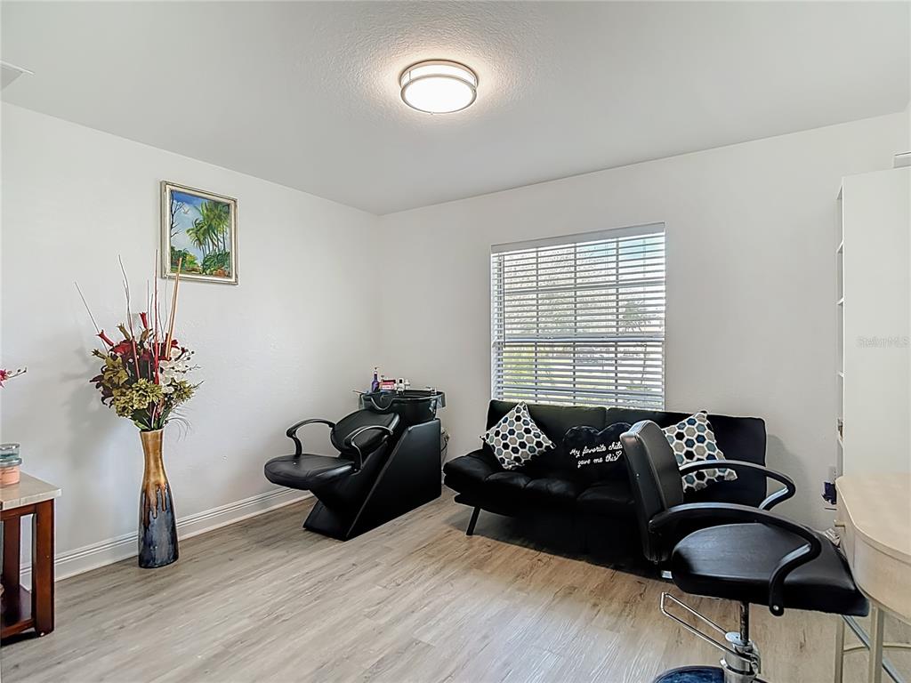 13108 Oneida Street Spring Hill, FL 34609 - Photo 22 of 62 a bedroom with furniture and a potted plant