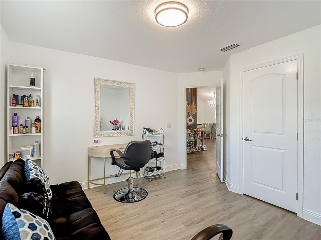 13108 Oneida Street Spring Hill, FL 34609 - Photo 24 of 62 a view of a workspace with furniture and wooden floor