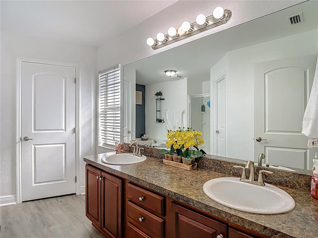 13108 Oneida Street Spring Hill, FL 34609 - Photo 28 of 62 a bathroom with double vanity sinks and a mirror