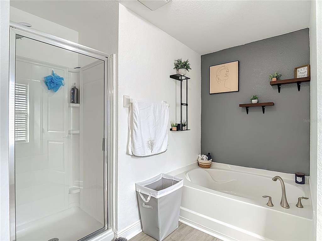 13108 Oneida Street Spring Hill, FL 34609 - Photo 29 of 62 a bathroom with a tub a window and a shower