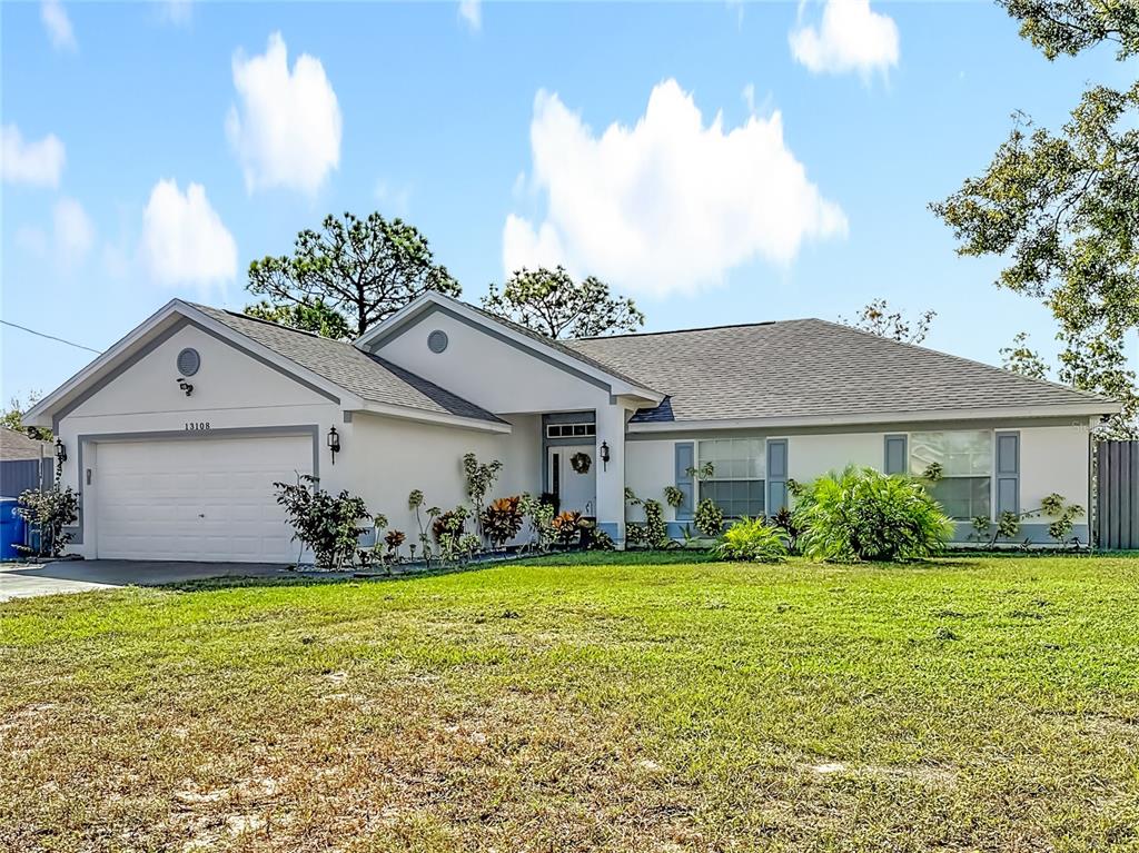13108 Oneida Street Spring Hill, FL 34609 - Photo 3 of 62 a front view of house with yard and green space