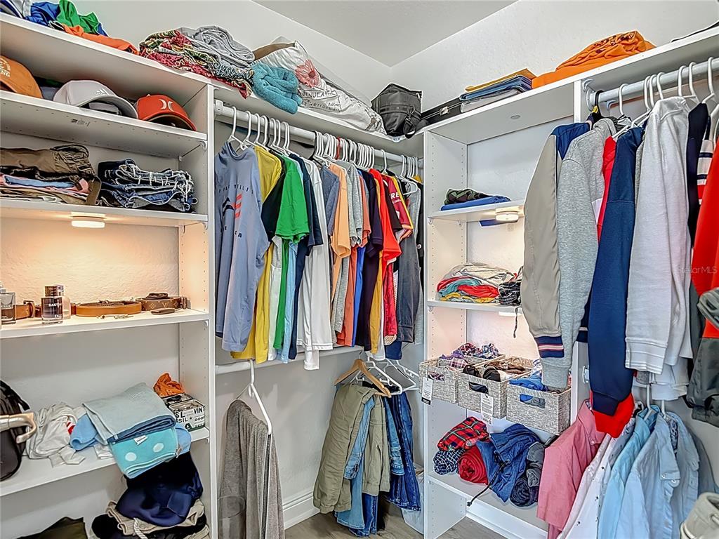 13108 Oneida Street Spring Hill, FL 34609 - Photo 32 of 62 a view of walk in closet with clothes and shoes