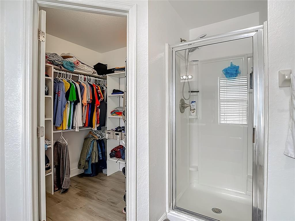 13108 Oneida Street Spring Hill, FL 34609 - Photo 33 of 62 a view of walk in closet with clothes and shoes
