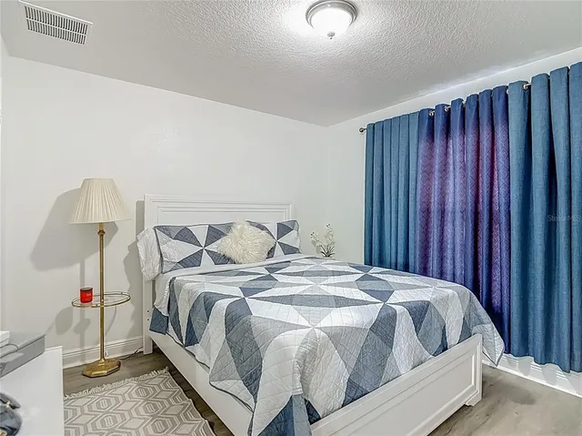 a bedroom with a bed and a mirror