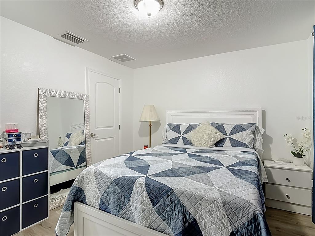 13108 Oneida Street Spring Hill, FL 34609 - Photo 36 of 62 a bedroom with a bed and a window