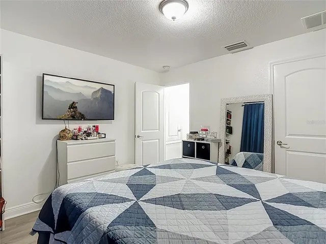 a bedroom with a bed and a dresser