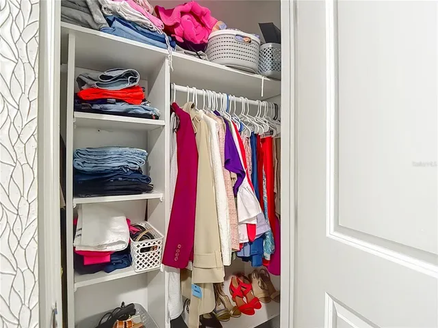 a bedroom with a bed and a mirror