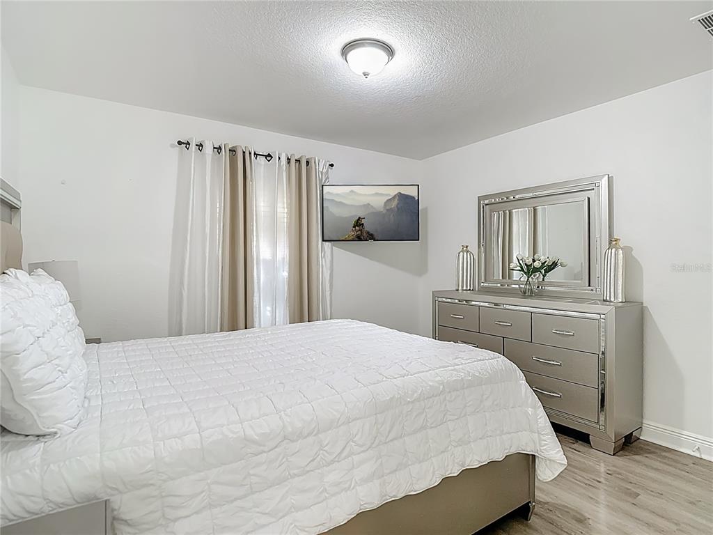 13108 Oneida Street Spring Hill, FL 34609 - Photo 39 of 62 a bedroom with a bed and a mirror