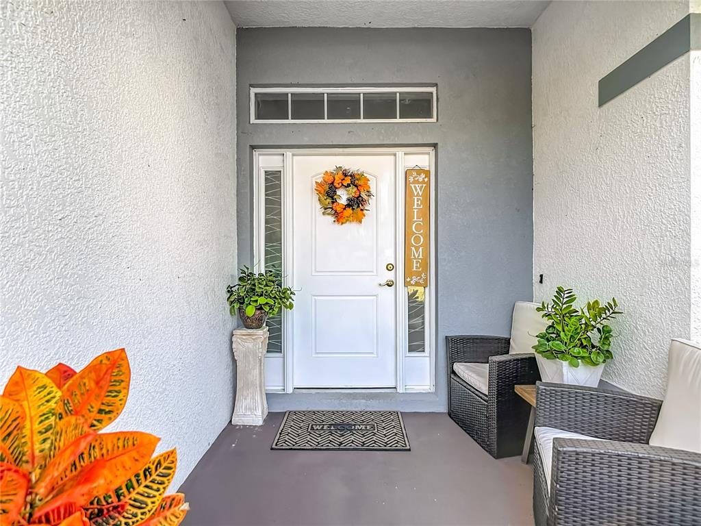 13108 Oneida Street Spring Hill, FL 34609 - Photo 4 of 62 a living room with furniture and flowers
