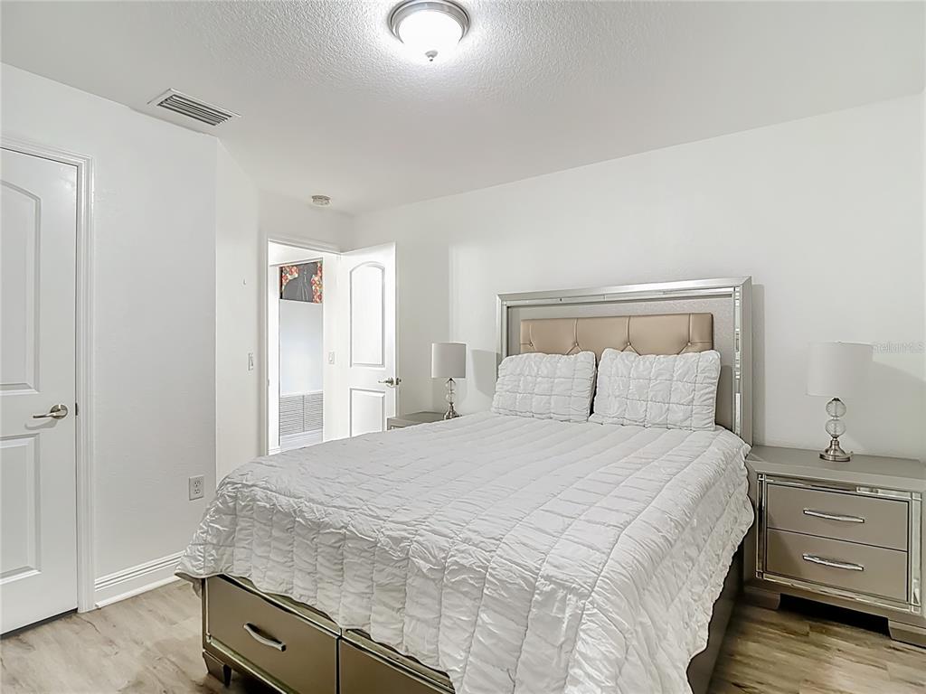 13108 Oneida Street Spring Hill, FL 34609 - Photo 41 of 62 a bedroom with a bed and a dresser