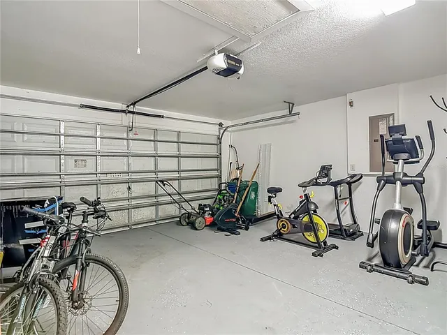 a view of a house with backyard and tree