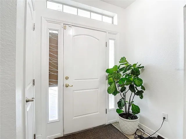 a living room with furniture chandelier and a window