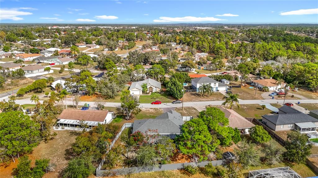 13108 Oneida Street Spring Hill, FL 34609 - Photo 62 of 62 an aerial view of residential houses with outdoor space and trees