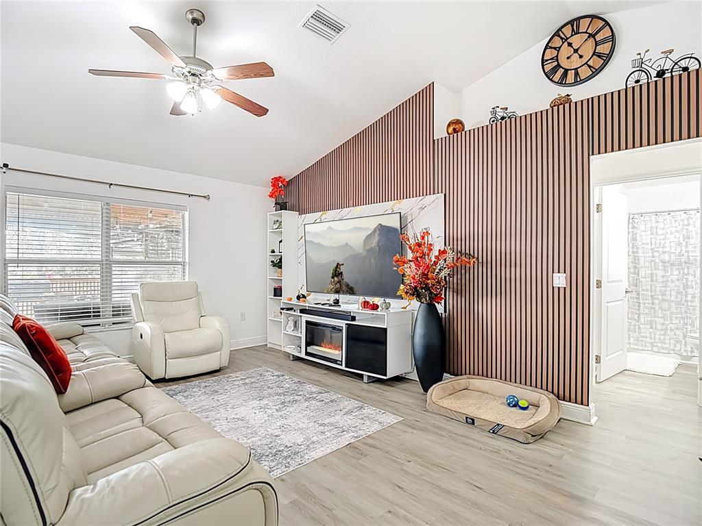 13108 Oneida Street Spring Hill, FL 34609 - Photo 7 of 62 a living room with furniture chandelier and a window