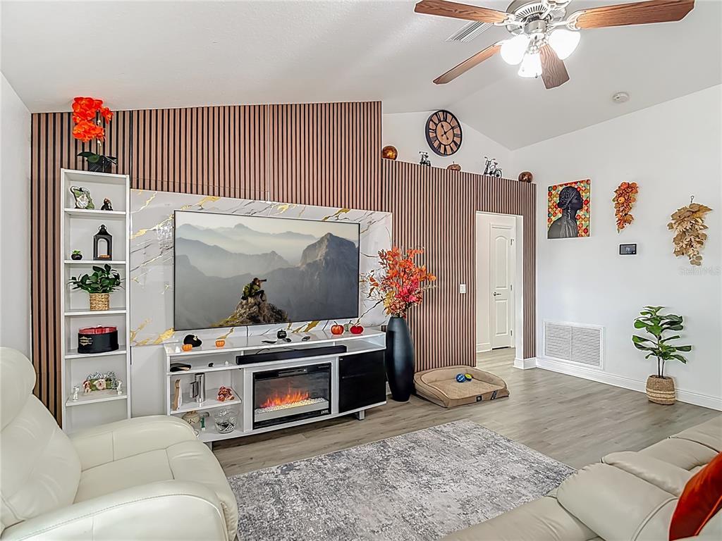 13108 Oneida Street Spring Hill, FL 34609 - Photo 10 of 62 a living room with furniture and a flat screen tv