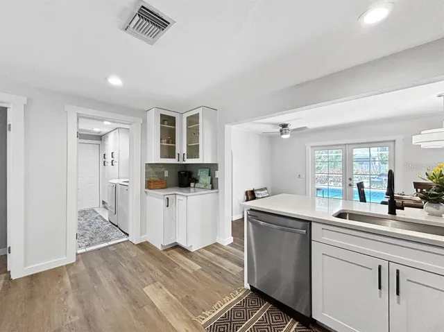 a kitchen that has a sink and a stove in it