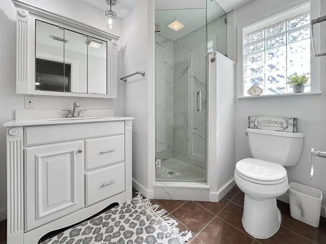a bathroom with a toilet sink and shower