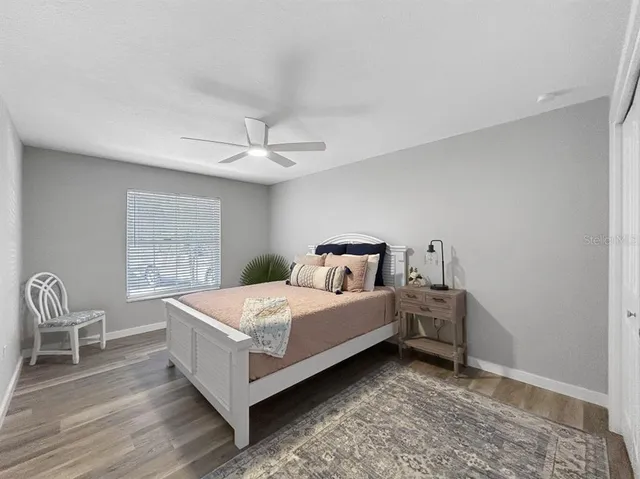 a bed room with a bed and chair